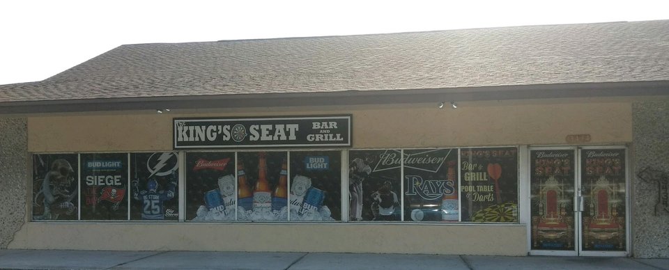 Casual bar tables with sports screens nearby.